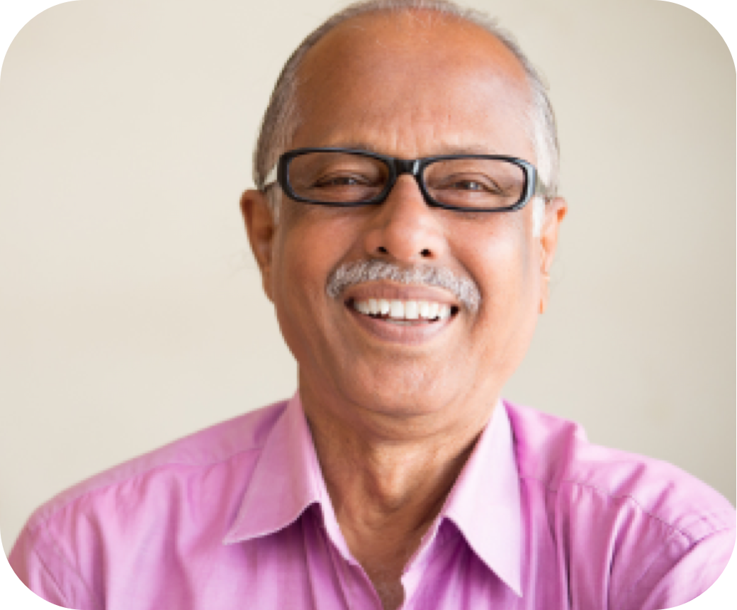Smiling man in glasses and pink shirt